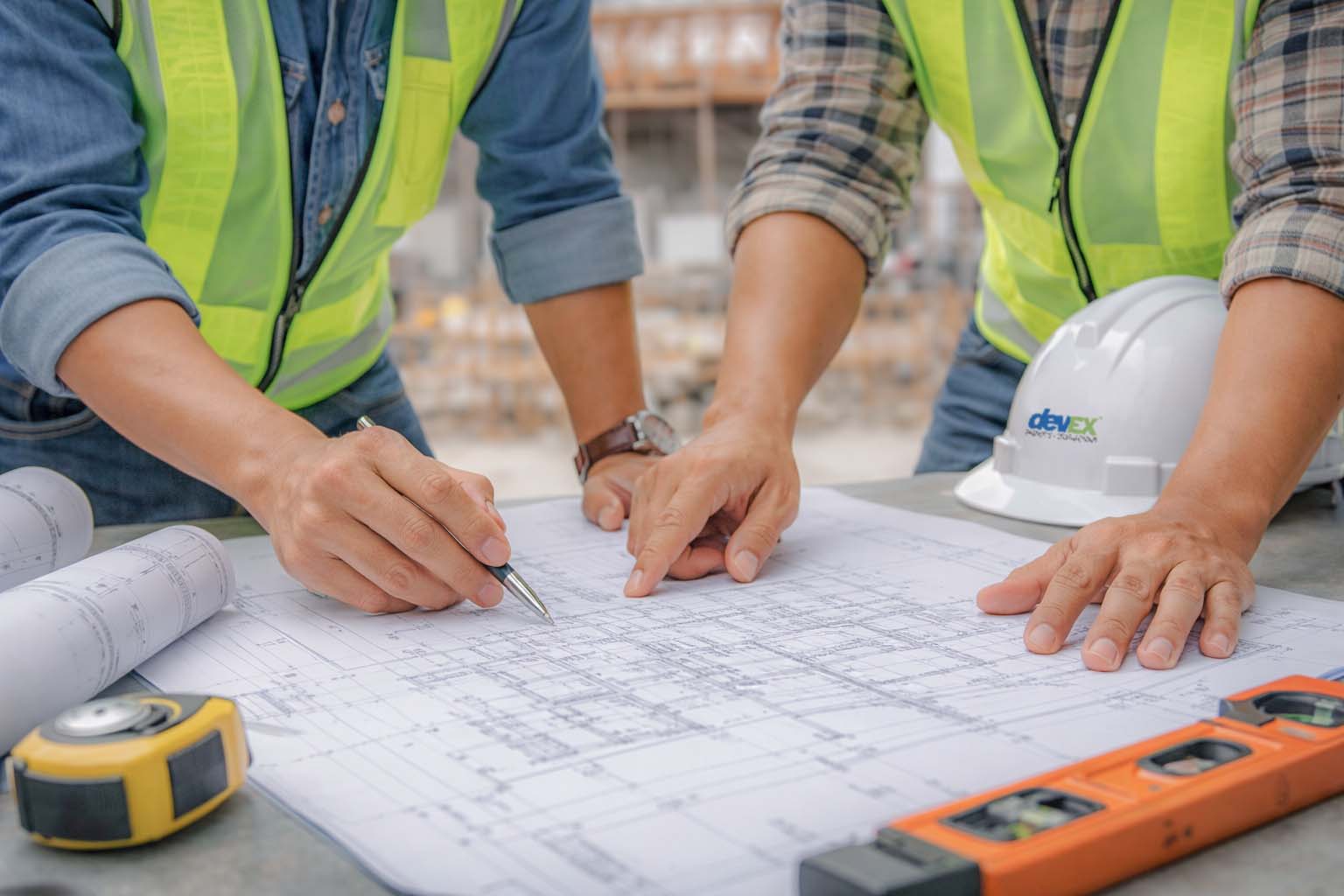 Two engineers discussing in a construction site.