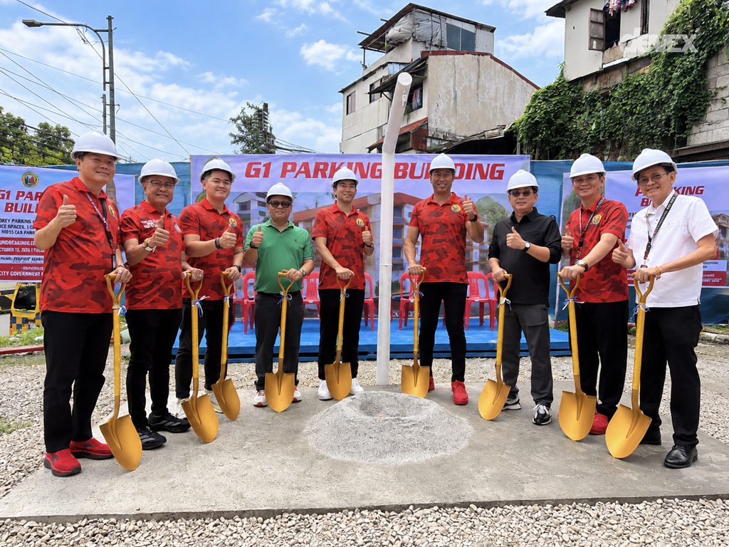 San Juan City officials and project representatives wearing hard hats hold ceremonial shovels during the G1 Parking Building groundbreaking ceremony.